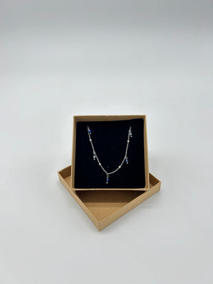 SILVER NECKLACE WITH BLUE CHARMS