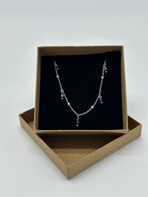 SILVER NECKLACE WITH BLUE CHARMS